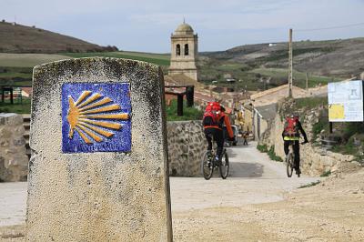 Cyclists on the St James way in an old village