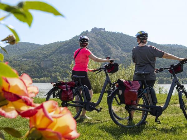 Cyclists with Visegrad in the background