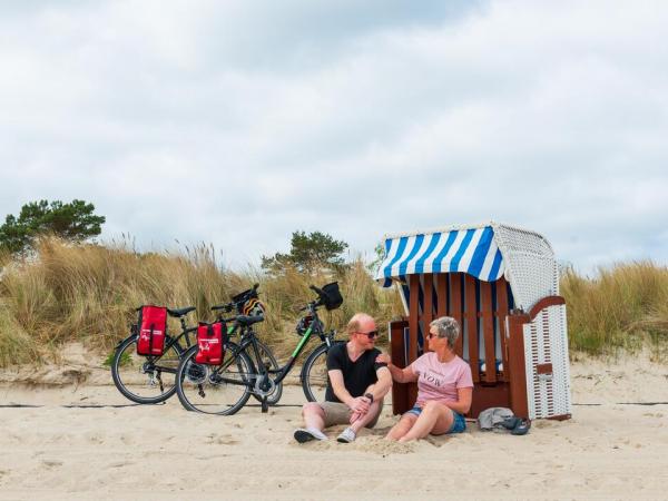 Radfahrer mit Strandkorb am Strand